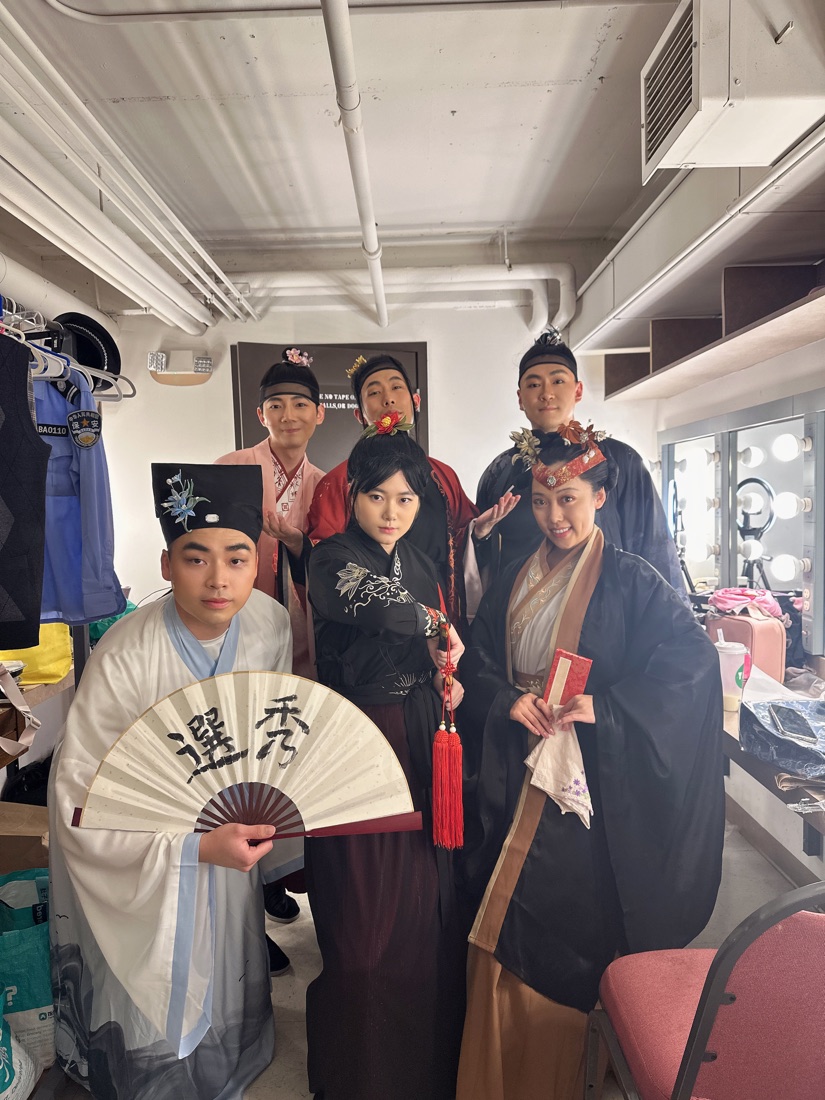 The Palace 101 ensemble poses together in costume backstage.