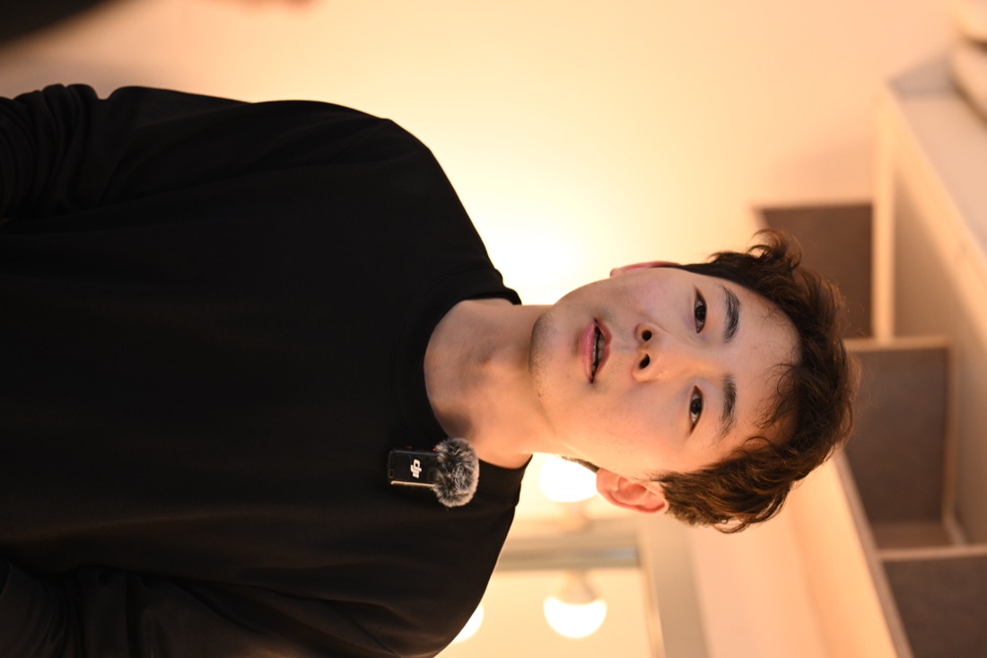 Hua speaks to camera while preparing backstage.
