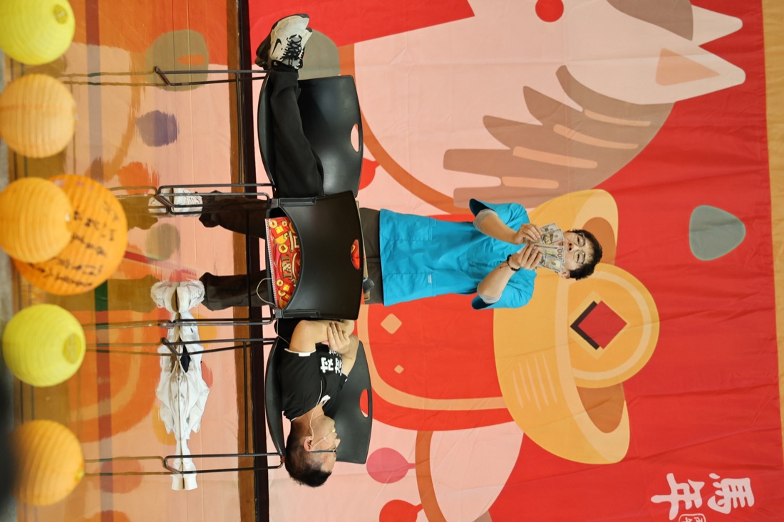 Video poster showing Hua performing as a surgeon on stage.