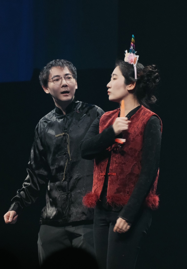 Video poster showing Hua performing in a black costume on stage.